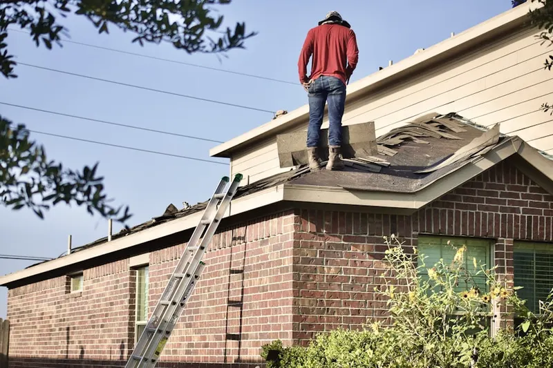 Professional roofer working on a residential roof in Bristow